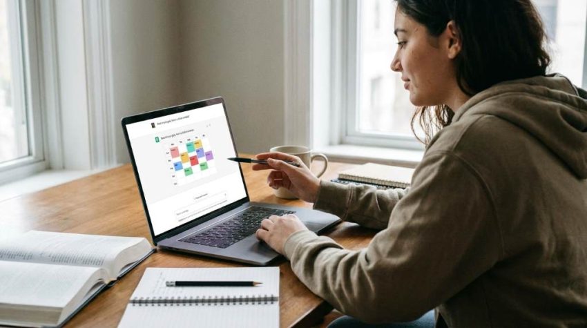 Student using AI app to create personalized study schedule on laptop at home