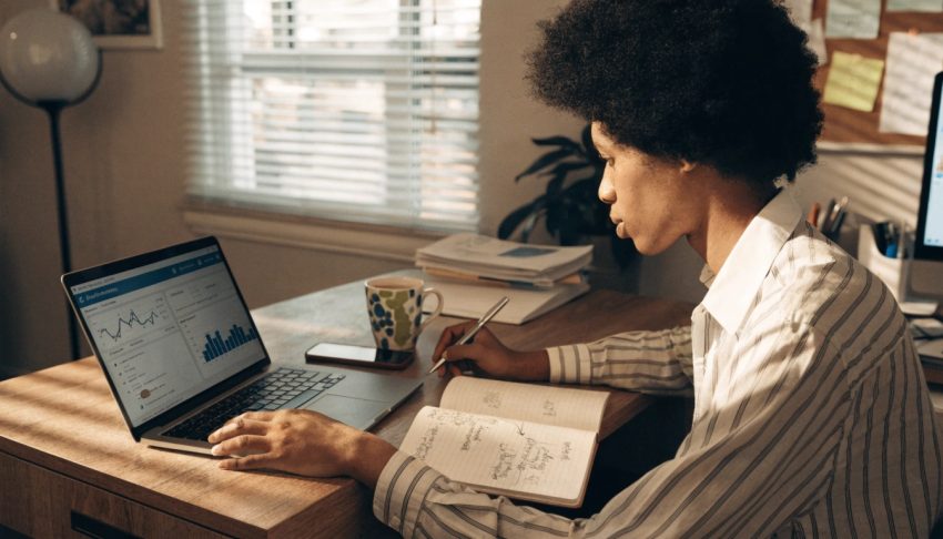 Affiliate marketer comparing email marketing performance with social media engagement metrics on a laptop dashboard