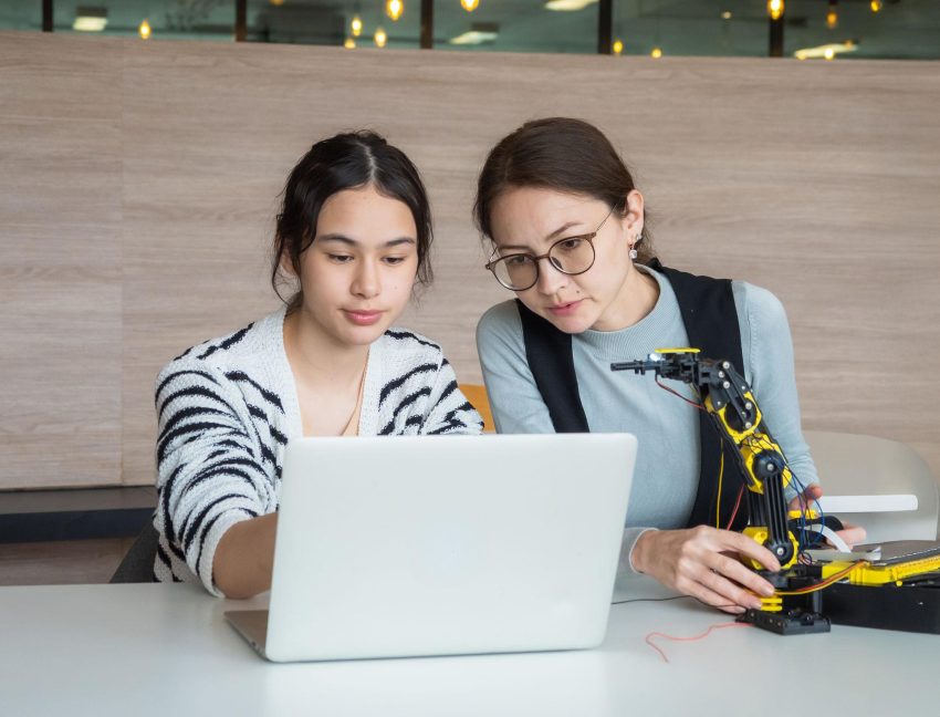 Teacher using AI powered educational technology with students in a modern classroom