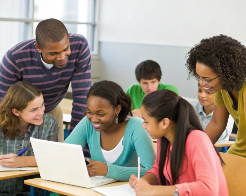 Students using digital tools to complete a group assignment in an inclusive classroom